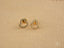 Gold heart-shaped stud earrings with cubic zirconia stones showcasing elegance meets romance