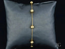 Delicate solid 18k gold bracelet with polished gold spheres