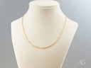 Delicate 18K gold chain necklace on cream mannequin