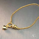Delicate 18k gold bracelet with heart charm and diamond-encrusted bead