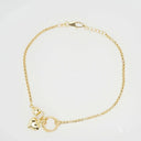Delicate 18k gold bracelet with heart, sparkling zirconia, and textured ring charms