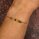 Delicate 18k solid gold kids id bracelet on womans wrist
