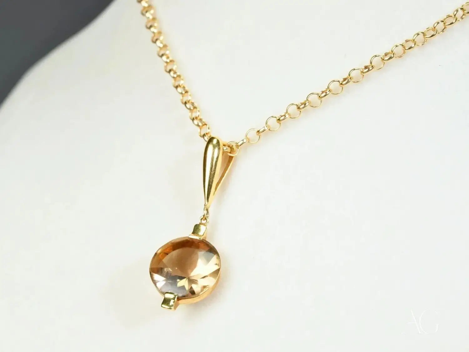 Teardrop amber gem on delicate gold chain in jewelry history