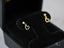 Matching gold CZ heart drop earrings with open-heart charm and clear gemstone detail
