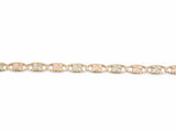 Detail of the diamond-cut rosette plates alternating rose and white gold inside yellow gold frames