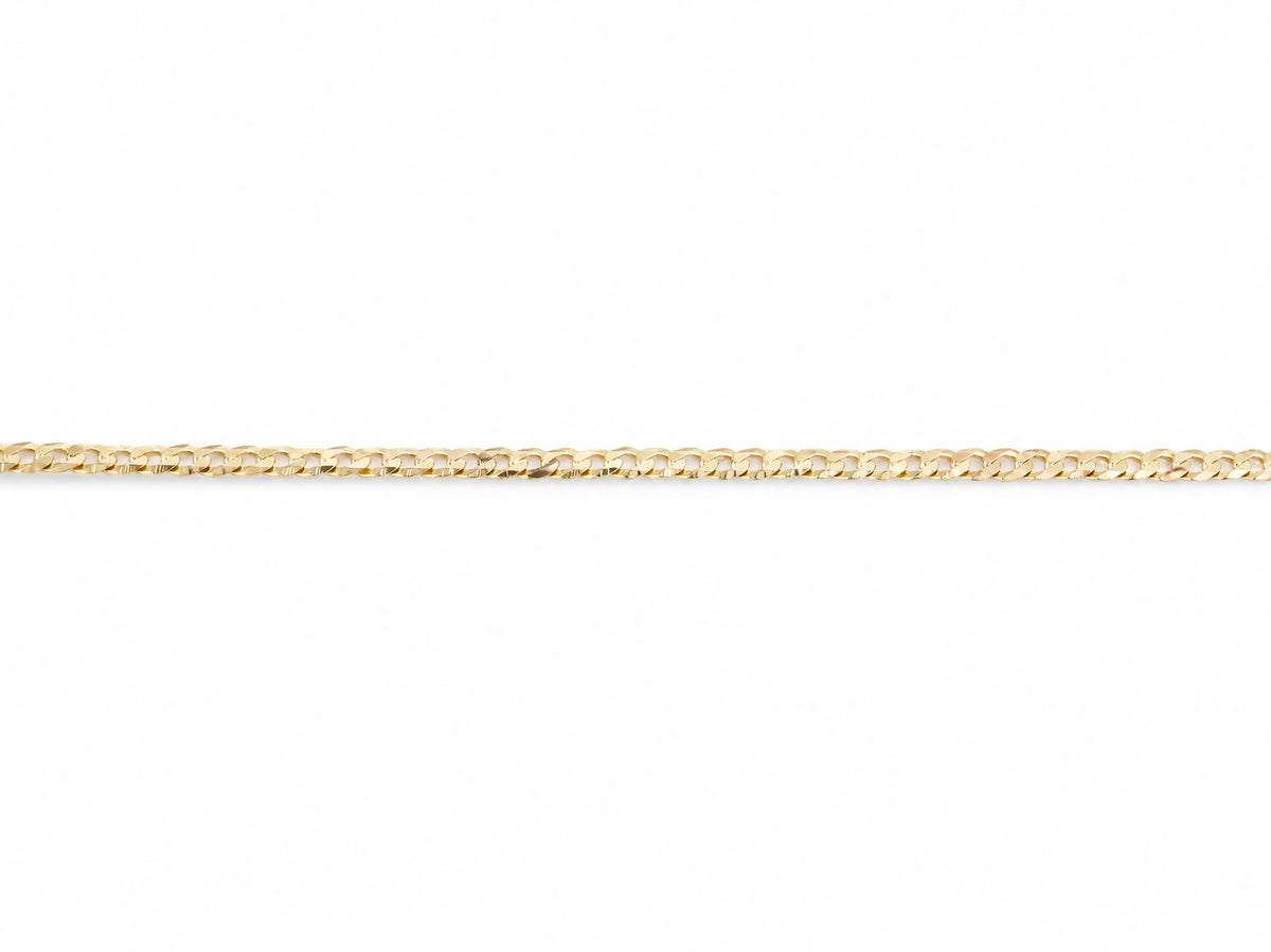 14K yellow gold Cuban chain laid straight with both ends visible