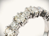 Diamond half-band wedding ring with nine graduated stones, extreme close-up of setting