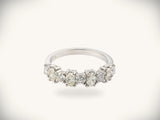Diamond half-band wedding ring with nine graduated stones, face-on front view