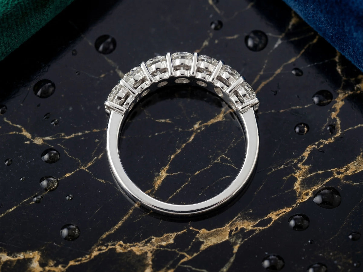 Diamond half-band wedding ring with nine graduated stones, overhead view of setting