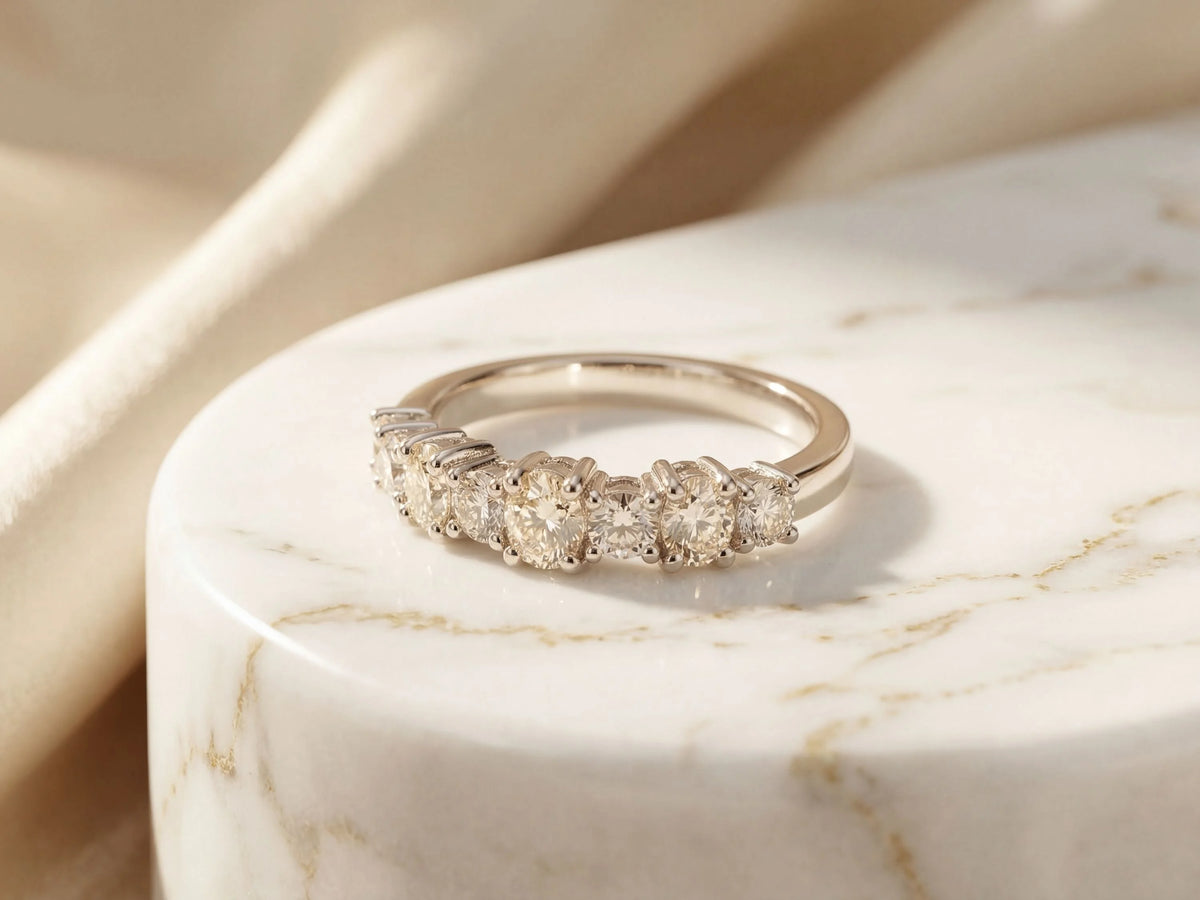 Diamond half-band wedding ring with nine graduated stones, side angle view