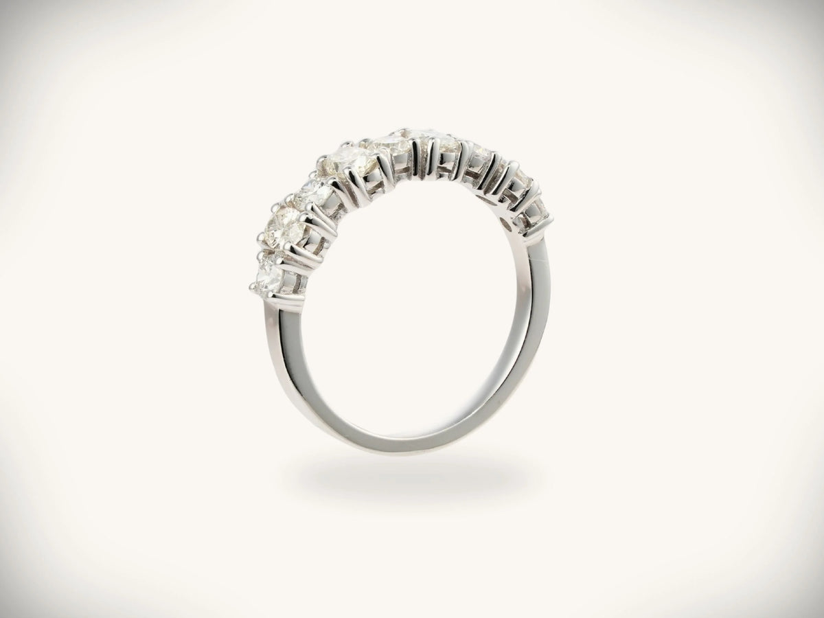 Diamond half-band wedding ring with nine graduated stones, side profile view