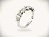 Diamond half-band wedding ring with nine graduated stones, three-quarter side view