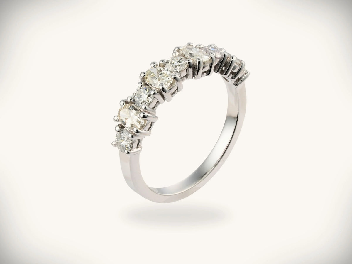 Diamond half-band wedding ring with nine graduated stones, three-quarter side view