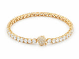 18K yellow gold zirconia tennis bracelet laid in a closed circle on white, one continuous row of round stones in four-prong settings, the pave-set spherical clasp at the front