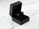 Pair of 18k gold cross CZ stud earrings in black velvet box