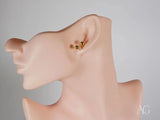 Certified 18k solid gold double ball earrings on ear model