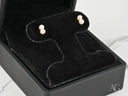 18K gold double pearl stud earrings in creamy white on black velvet