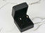 Open black velvet earring box with double white pearl art gold jewelry studs