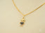 Gold necklace with boy-shaped pendant featuring black and white gemstones, part of Dual Elegance Pendant art gold jewelry collection in 18k solid gold