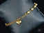 Elegant 18k gold bracelet with heart motif and polished gold beads for women