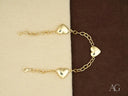 Two delicate 18k gold heart bracelets with puffed heart charms