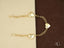 Elegant 18k gold bracelet with three delicate heart charms and pure 18k gold finish