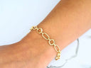 Elegant 18k gold bracelet on wrist, sophisticated chain link design