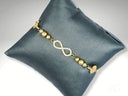 Stunning 18k gold bracelet with infinity charm and cubic zirconia