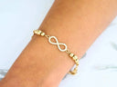 Stunning 18k gold infinity bracelet with pavé diamonds and beaded chain
