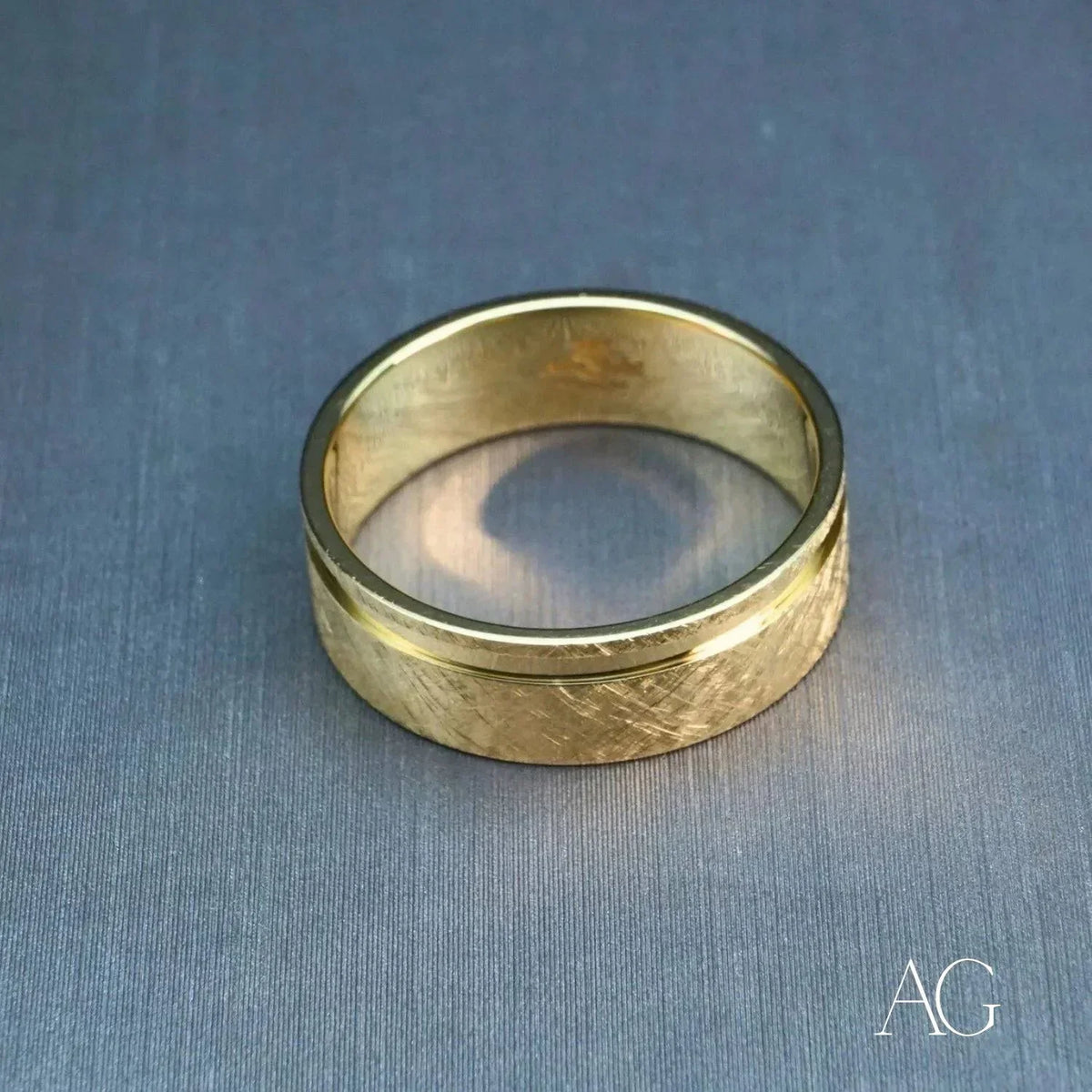 Elegant 18k gold diamond wedding band with textured gold and polished rim