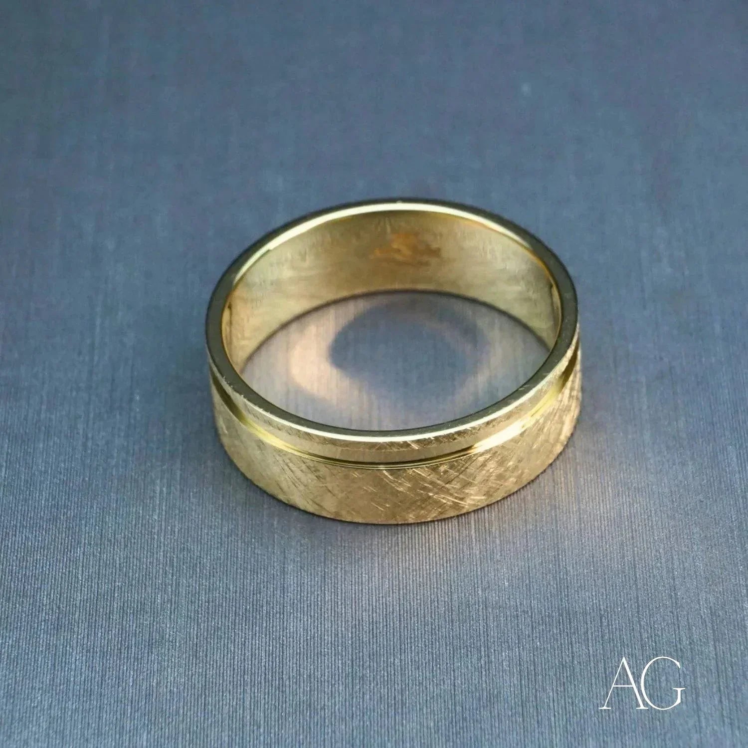 Elegant 18k gold diamond wedding band with textured gold and polished rim