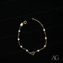 Elegant 18k gold heart and pearl bracelet with small pearls