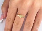 Elegant 18k gold heart ring with diamond band centerpiece