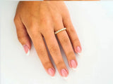 Exquisite half-round 18k yellow gold CZ ring with French-manicured hand and diamond eternity band for timeless elegance