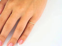 Elegant 18k yellow gold square shape ring on hand with French-tipped nails