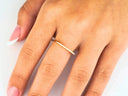 Elegant 18k yellow gold square shape ring with small diamond on finger