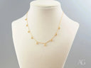 Elegant 18K gold beaded necklace with delicate spherical charms