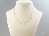 Elegant 18K gold beaded necklace with delicate spherical charms