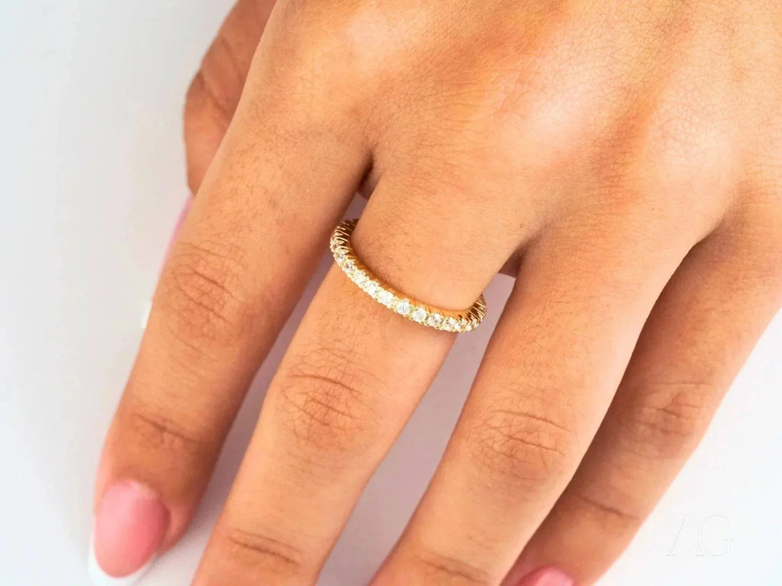 Elegant 18k gold diamond eternity band on finger