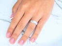Elegant white 18k gold wedding band on hand with French-tipped nails