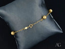 Elegant solid 18k gold bracelet with luxurious gold orbs and spring ring clasp