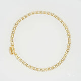 Elegant yellow gold tennis bracelet with rectangular zirconia diamonds