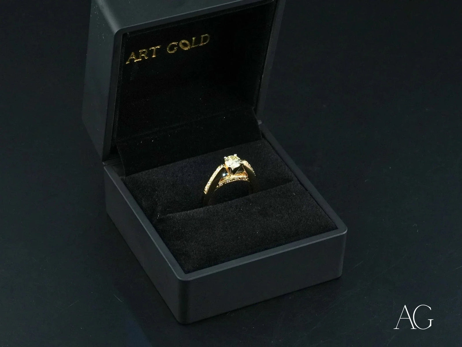 Open 18k gold light engagement ring with square diamond in black box