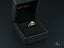 Open black ring box with 18k gold engagement ring featuring a square-cut diamond, showcasing a light engagement ring with a cradling effect