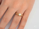 18k gold light engagement ring with round diamond and pavé band