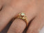 Yellow gold Embrace of Light engagement ring with light yellow diamond and pavé-set diamonds