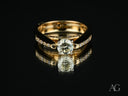 Embrace of Light 18k gold engagement ring with round brilliant diamond and pavé band