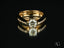 Embrace of Light Engagement Ring featuring a round brilliant diamond and pavé diamonds in 18k gold with a cradling effect