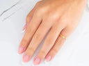 Womans hand with French-tipped nails wearing 18k yellow gold CZ heart ring