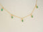 Gold chain necklace with six marquise-cut emeralds and emerald droplets in 18k gold